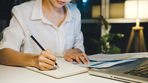 Freelance Asia lady using laptop hard work in living room at hou